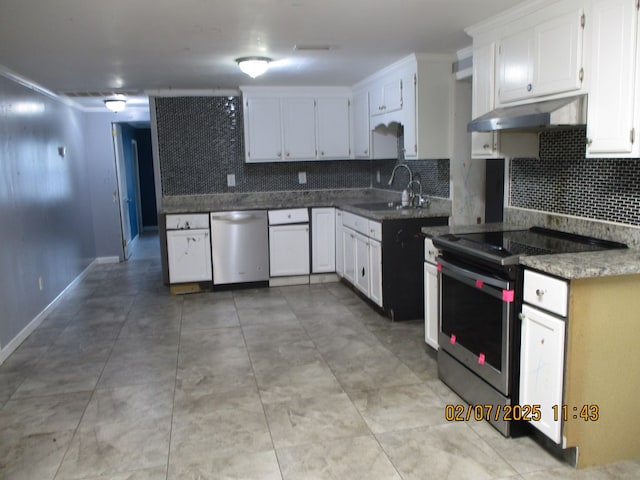 kitchen with appliances with stainless steel finishes, sink, white cabinets, backsplash, and light tile patterned floors
