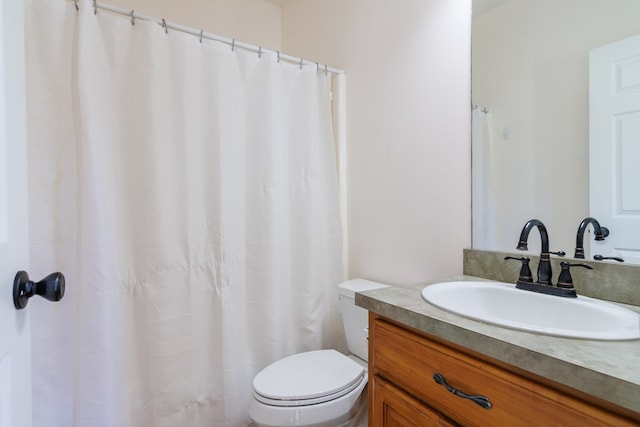 bathroom featuring toilet and vanity