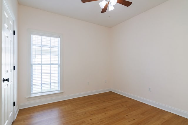 empty room featuring light wood-style floors, baseboards, and a ceiling fan