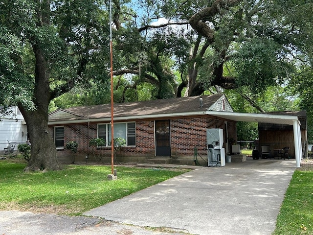 single story home with a front yard and a carport