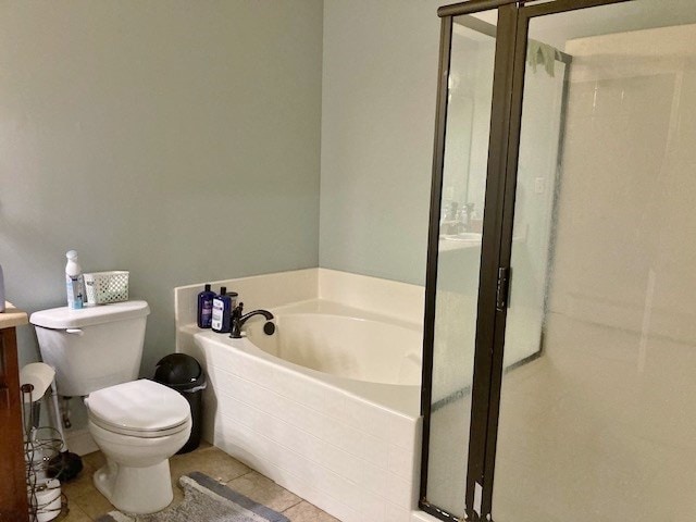 bathroom featuring a washtub, tile patterned floors, and toilet