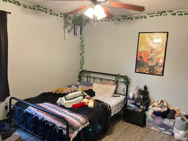 bedroom with hardwood / wood-style flooring and ceiling fan