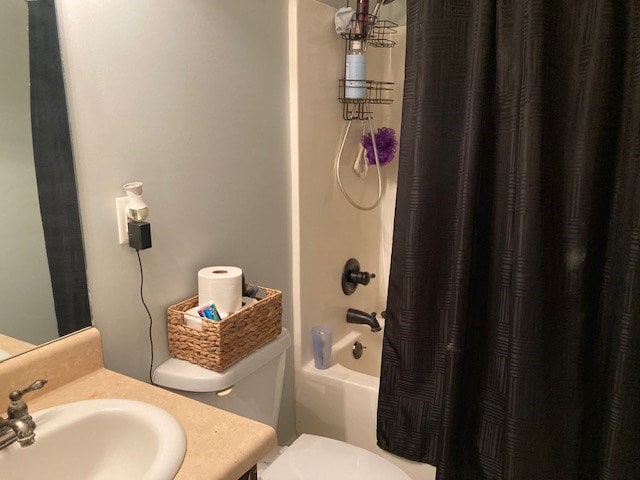 full bathroom with vanity, shower / tub combo with curtain, and toilet