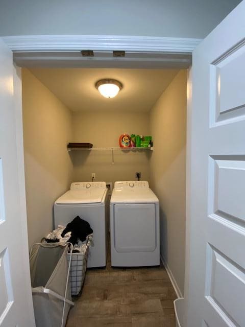 laundry area featuring laundry area, washer and clothes dryer, and wood finished floors