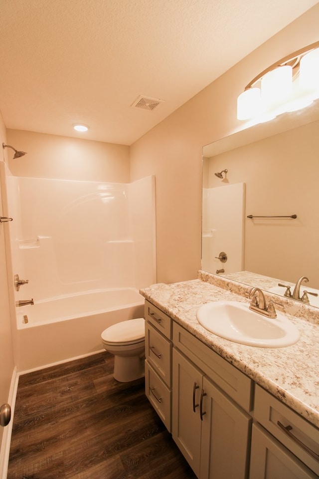 593 Jamar Trl, Quitman, GA 31643 - full bath with vanity, toilet, shower / washtub combination, wood finished floors, and recessed lighting