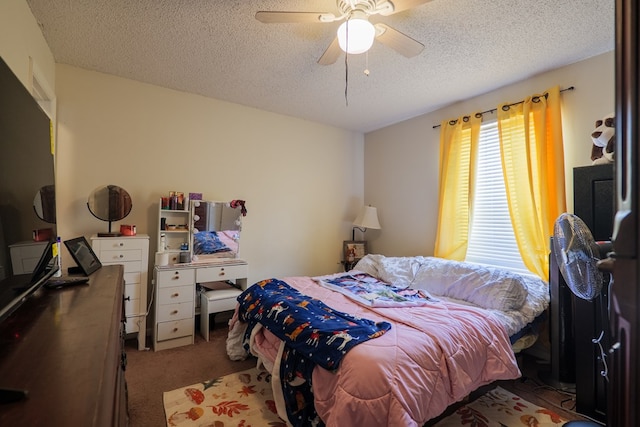 carpeted bedroom featuring ceiling fan and a textured ceiling