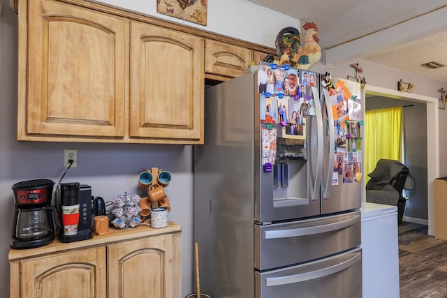 kitchen featuring dark hardwood / wood-style floors, stainless steel fridge with ice dispenser, a textured ceiling, and light brown cabinets