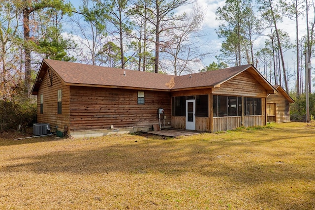 exterior space featuring central AC unit, a yard, and a sunroom