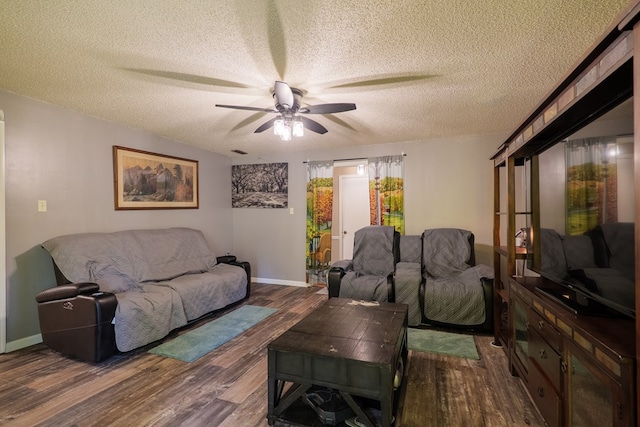 living room featuring hardwood / wood-style floors, a textured ceiling, and ceiling fan