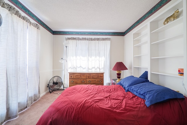 carpeted bedroom featuring a textured ceiling