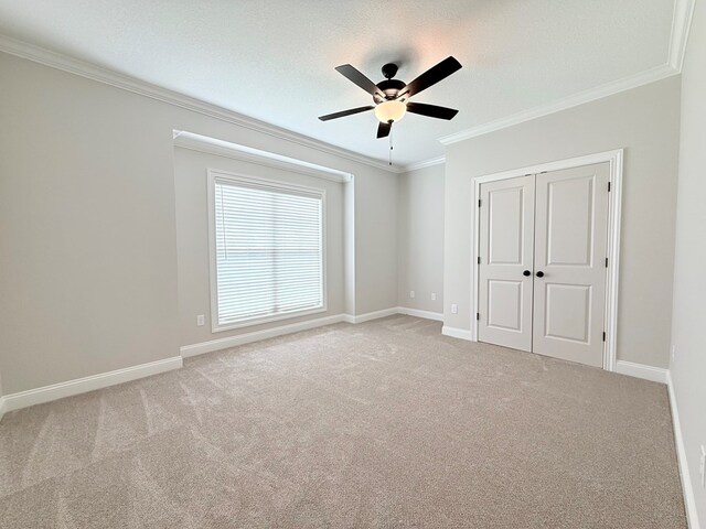 4965 Hatfield Cir, Hahira, GA 31632 - unfurnished bedroom featuring ornamental molding, baseboards, carpet floors, a closet, and a ceiling fan