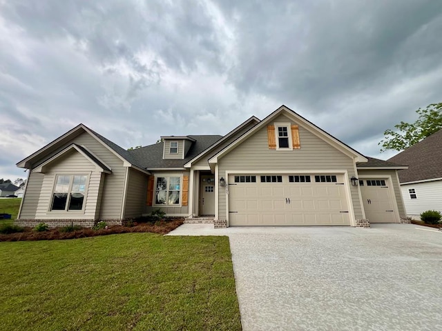 4965 Hatfield Cir, Hahira, GA 31632 - view of front facade with an attached garage, concrete driveway, a front lawn, and a shingled roof