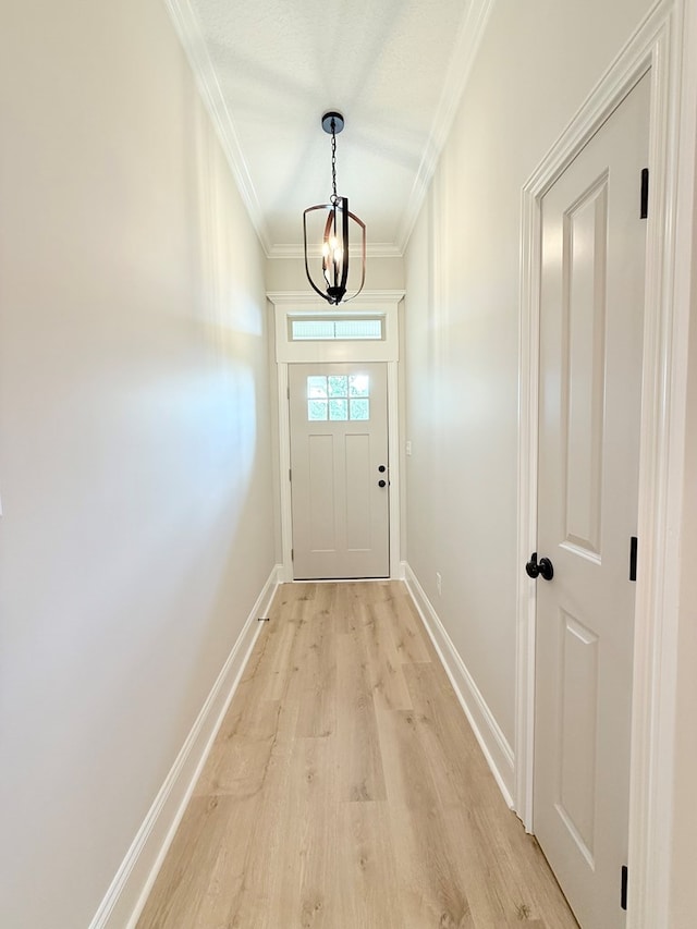 4965 Hatfield Cir, Hahira, GA 31632 - entryway featuring ornamental molding, light wood-type flooring, a chandelier, and baseboards