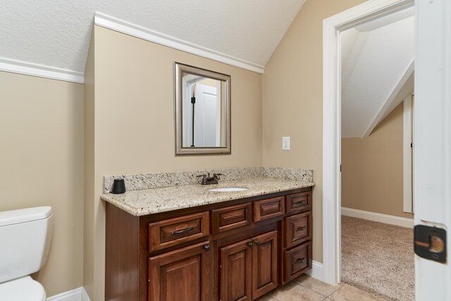 5527 School House Pond Rd, Lake Park, GA 31636 - bathroom featuring vaulted ceiling, vanity, a textured ceiling, toilet, and tile patterned floors
