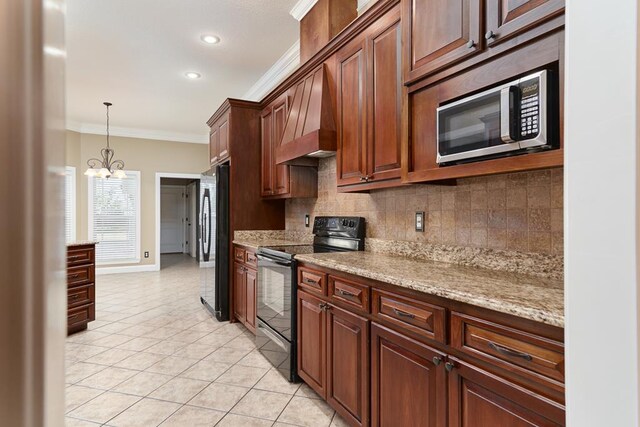 5527 School House Pond Rd, Lake Park, GA 31636 - kitchen with black electric range, stainless steel microwave, freestanding refrigerator, crown molding, and light tile patterned floors