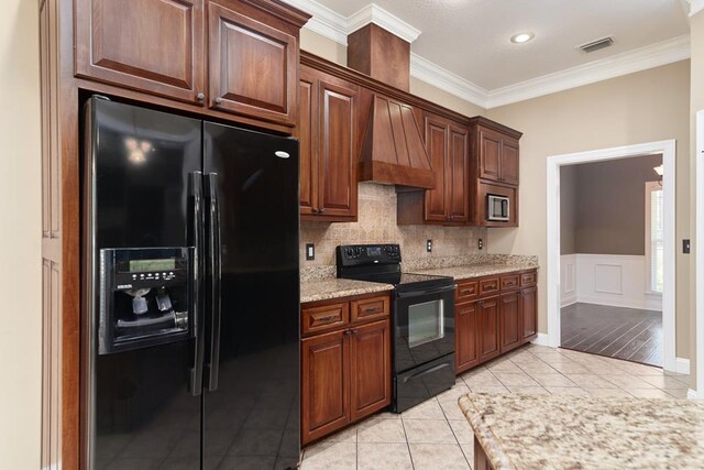 5527 School House Pond Rd, Lake Park, GA 31636 - kitchen featuring black appliances, custom range hood, crown molding, light tile patterned floors, and tasteful backsplash