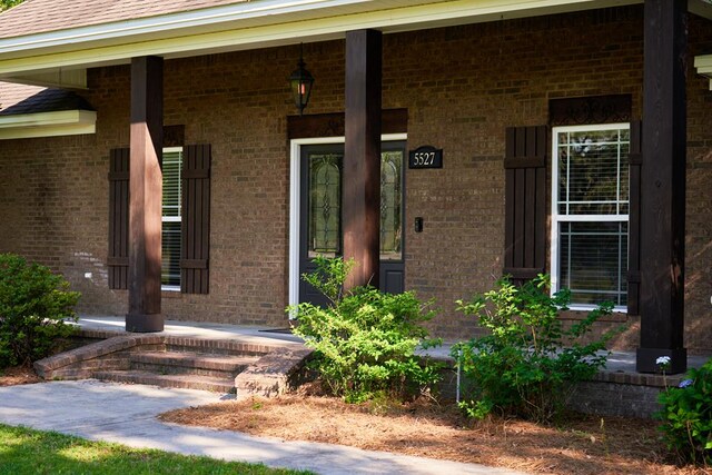 5527 School House Pond Rd, Lake Park, GA 31636 - doorway to property featuring covered porch and brick siding