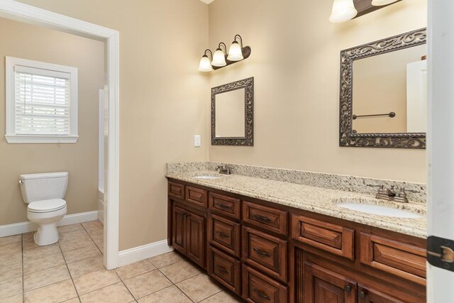 5527 School House Pond Rd, Lake Park, GA 31636 - bathroom with toilet, double vanity, tile patterned flooring, and baseboards