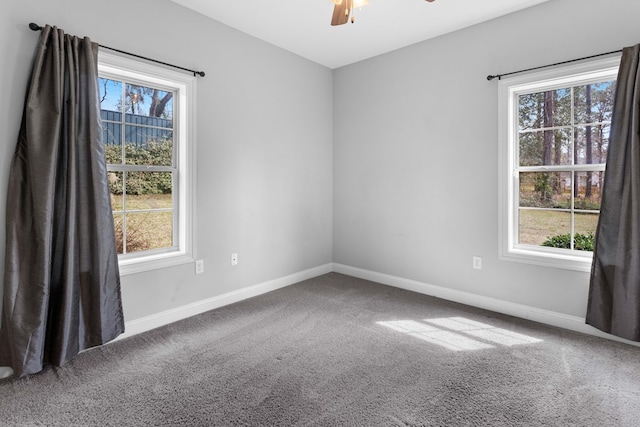 empty room with carpet, ceiling fan, and baseboards