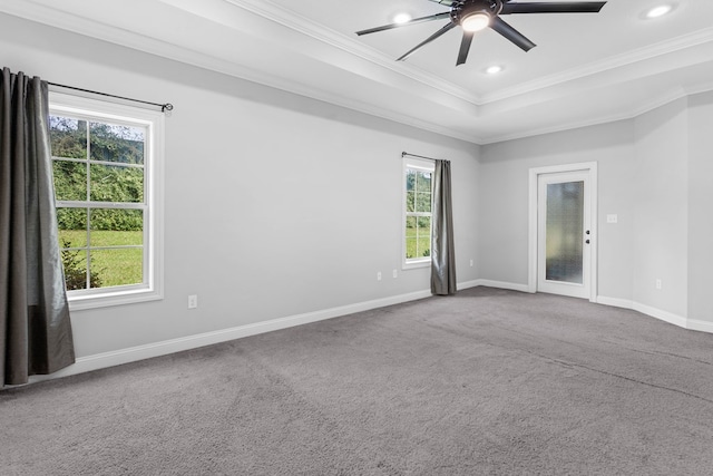 unfurnished room featuring carpet floors, ornamental molding, a ceiling fan, and baseboards