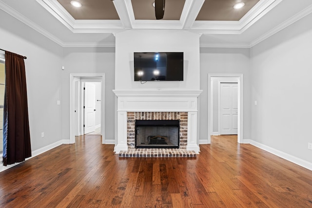 unfurnished living room with ornamental molding, a brick fireplace, coffered ceiling, and hardwood / wood-style flooring