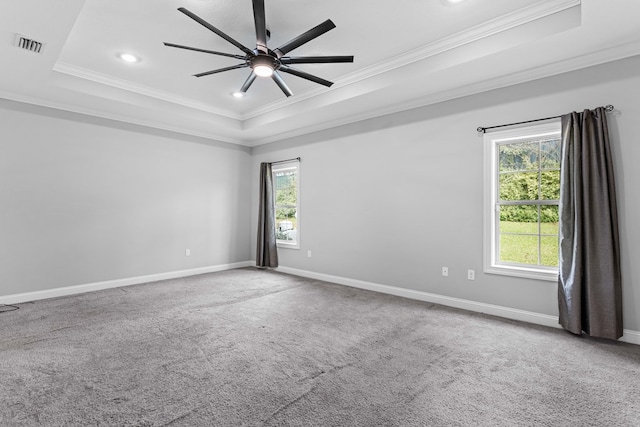 unfurnished room featuring carpet floors, visible vents, and a raised ceiling