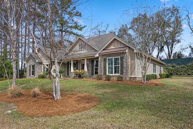 craftsman-style house with board and batten siding, brick siding, and a front lawn