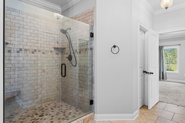 bathroom with a stall shower, baseboards, crown molding, and tile patterned floors