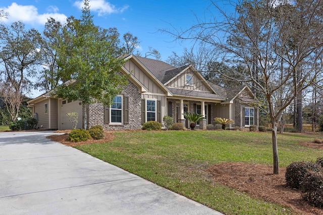 craftsman inspired home with brick siding, board and batten siding, a front yard, a garage, and driveway