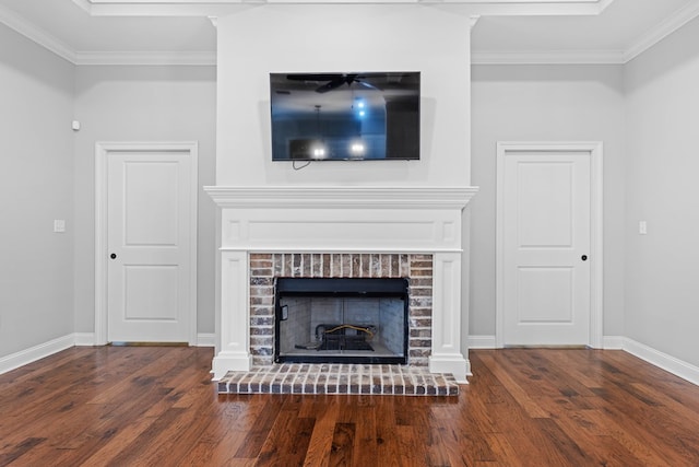 unfurnished living room featuring crown molding, a fireplace, baseboards, and wood finished floors