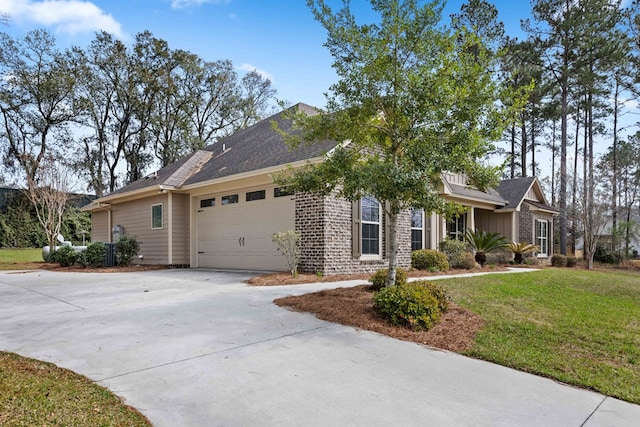 view of front of home with a garage, concrete driveway, a front lawn, and brick siding