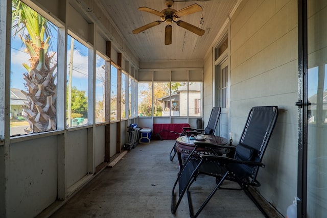 sunroom / solarium with ceiling fan and wooden ceiling