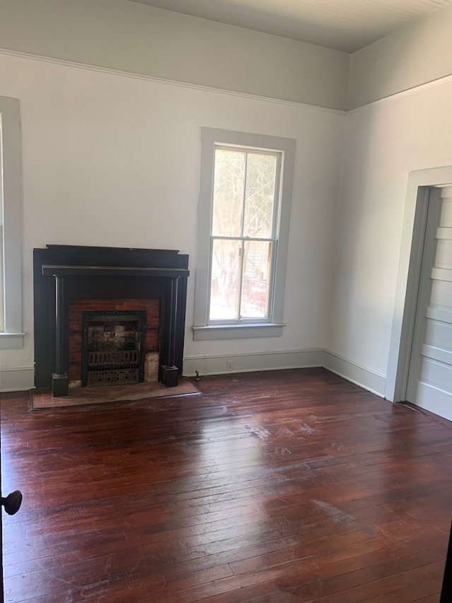 unfurnished living room featuring dark hardwood / wood-style flooring