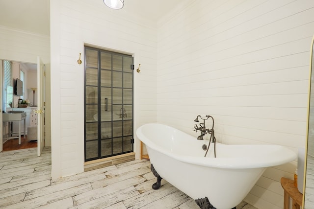 7552 Webb Rd, Hahira, GA 31632 - bathroom featuring wood finished floors, a freestanding bath, and ornamental molding