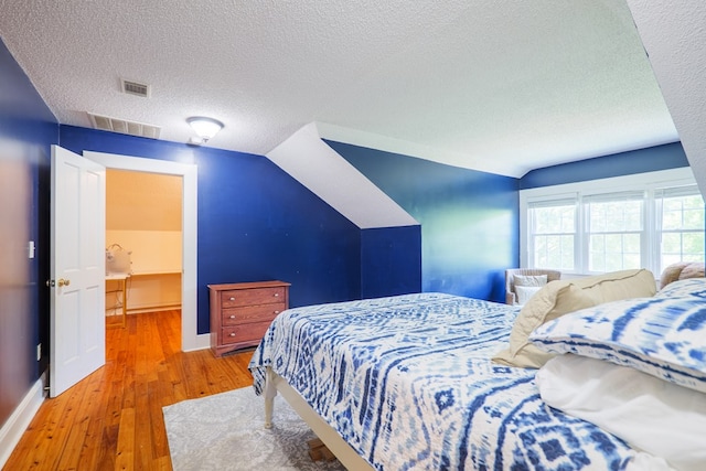 7552 Webb Rd, Hahira, GA 31632 - bedroom featuring a textured ceiling, hardwood / wood-style floors, and vaulted ceiling