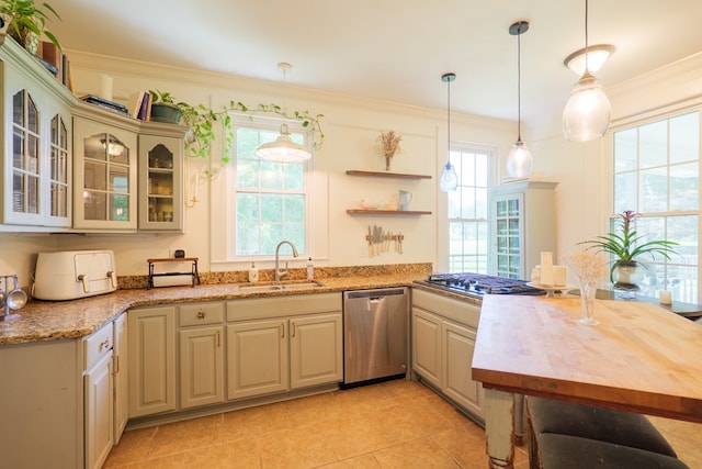 7552 Webb Rd, Hahira, GA 31632 - kitchen featuring appliances with stainless steel finishes, plenty of natural light, ornamental molding, pendant lighting, and glass insert cabinets