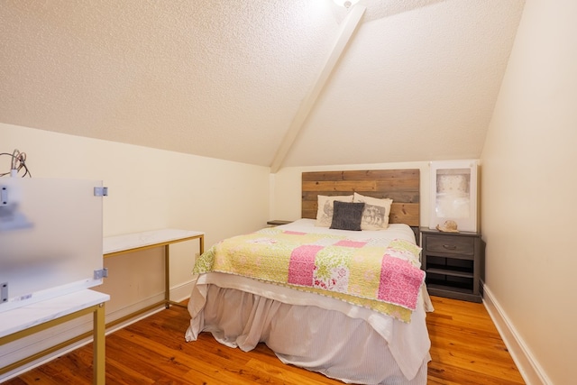 7552 Webb Rd, Hahira, GA 31632 - bedroom with lofted ceiling, wood finished floors, and a textured ceiling