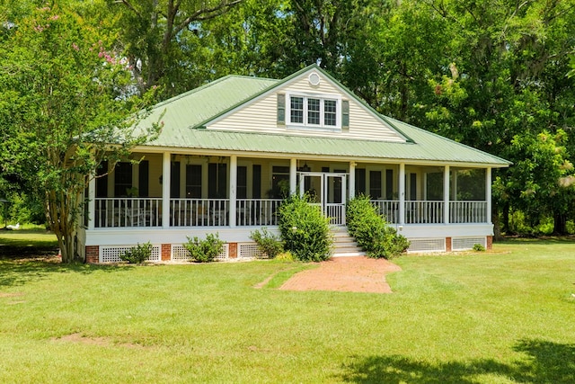 7552 Webb Rd, Hahira, GA 31632 - view of front of home featuring a sunroom, a front lawn, and a metal roof