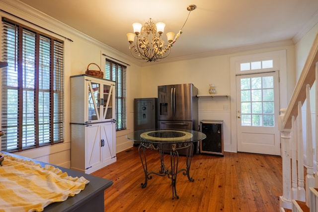 7552 Webb Rd, Hahira, GA 31632 - dining room featuring wine cooler, a chandelier, ornamental molding, wood-type flooring, and stairs