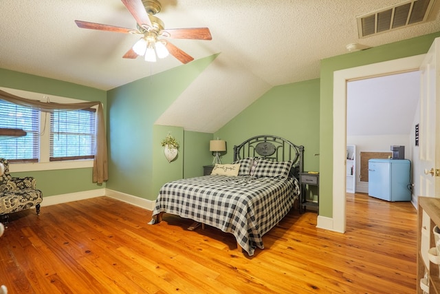 7552 Webb Rd, Hahira, GA 31632 - bedroom with vaulted ceiling, hardwood / wood-style flooring, a textured ceiling, and ceiling fan