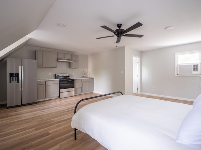 103 W Moore St, Valdosta, GA 31602 - bedroom featuring stainless steel refrigerator with ice dispenser, light wood finished floors, cooling unit, a sink, and baseboards