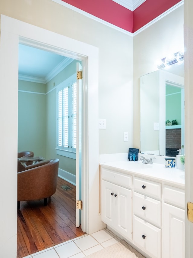 103 W Moore St, Valdosta, GA 31602 - bathroom with ornamental molding, vanity, and tile patterned floors