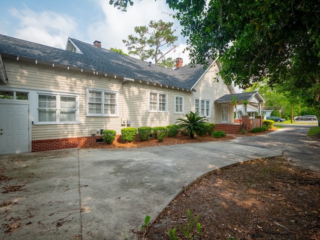 103 W Moore St, Valdosta, GA 31602 - view of property exterior featuring roof with shingles and a chimney