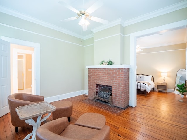 103 W Moore St, Valdosta, GA 31602 - living area featuring a ceiling fan, hardwood / wood-style floors, crown molding, a fireplace, and baseboards