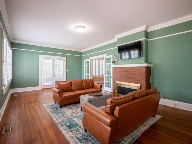 103 W Moore St, Valdosta, GA 31602 - living area with baseboards, a brick fireplace, crown molding, and wood finished floors