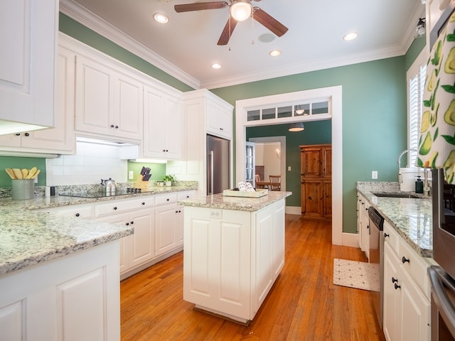 103 W Moore St, Valdosta, GA 31602 - kitchen featuring stainless steel appliances, a sink, a ceiling fan, white cabinetry, and tasteful backsplash