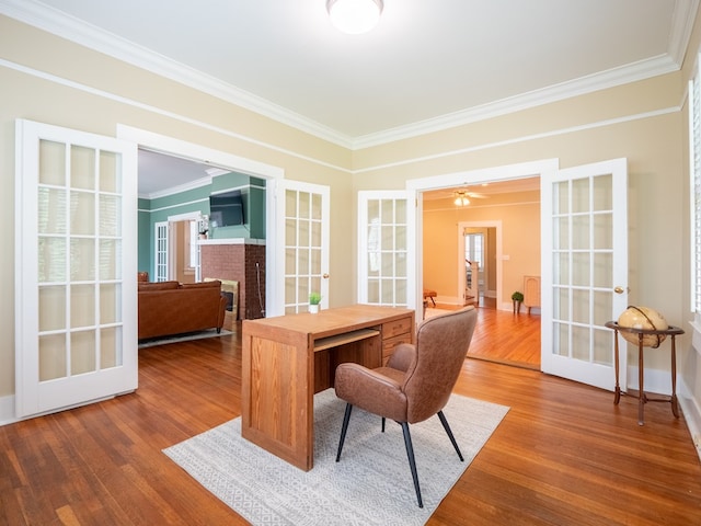 103 W Moore St, Valdosta, GA 31602 - office with french doors, ornamental molding, wood finished floors, baseboards, and a brick fireplace