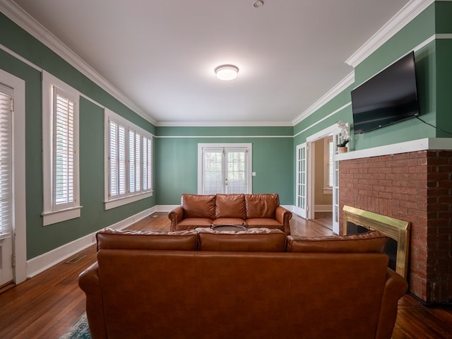 103 W Moore St, Valdosta, GA 31602 - living area with a brick fireplace, wood finished floors, crown molding, and baseboards