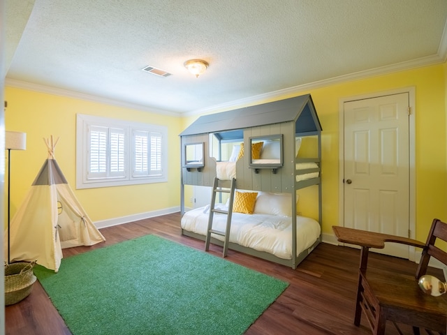 103 W Moore St, Valdosta, GA 31602 - bedroom with ornamental molding, wood finished floors, a textured ceiling, and baseboards