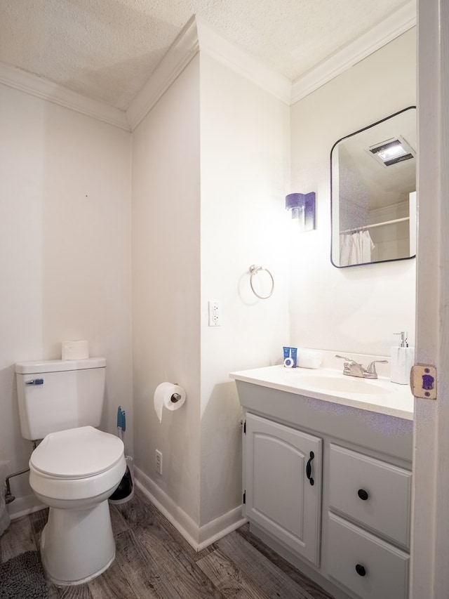 103 W Moore St, Valdosta, GA 31602 - full bathroom with wood finished floors, vanity, ornamental molding, toilet, and baseboards